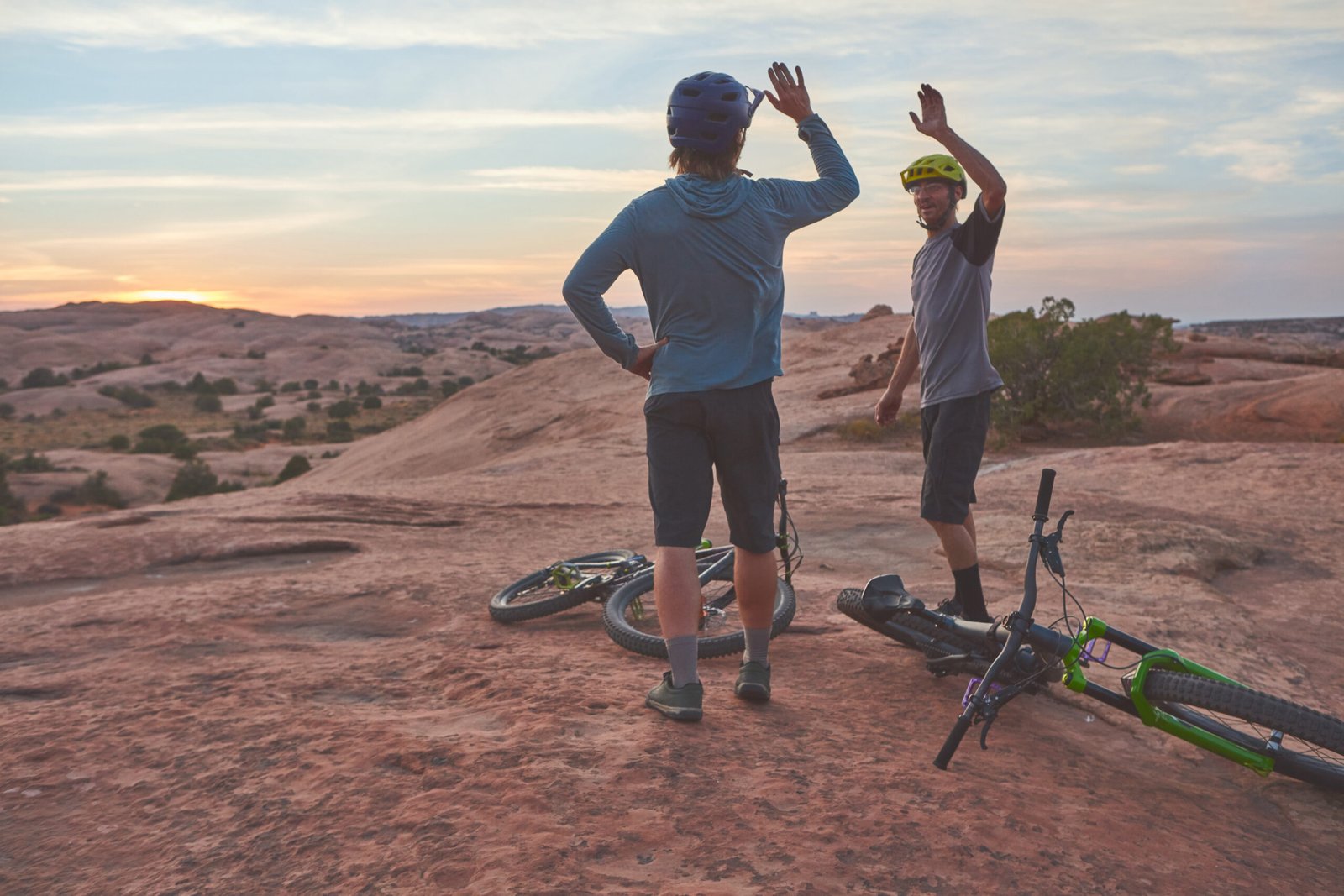 happy-men-and-mountain-biking-with-high-five-in-n-2026-05-19-16-29-15-utc